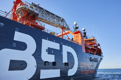 Offshore experience ship with large "BED" letters and equipment on deck.